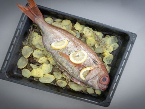 Besugo al horno con patatas y rodajas de limón Besugo al horno con patatas y rodajas de limón